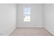 Well-lit bedroom features neutral carpet and a window providing natural light at 41 Alderman Ct # 2, Dunn, NC 28334