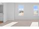 Bright bedroom with carpet and two windows with a view of a house outside at 41 Alderman Ct # 2, Dunn, NC 28334
