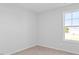 Neutral carpeted bedroom features a window providing natural light at 41 Alderman Ct # 2, Dunn, NC 28334