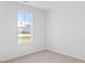 Cozy bedroom featuring neutral carpet, white walls, and a bright window at 41 Alderman Ct # 2, Dunn, NC 28334