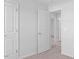 Hallway with neutral carpet and white doors at 41 Alderman Ct # 2, Dunn, NC 28334