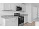 Modern kitchen featuring white cabinets, stainless steel appliances, granite countertops and hardwood floors at 41 Alderman Ct # 2, Dunn, NC 28334