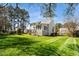 Expansive backyard featuring a well-manicured lawn, mature trees, and a sunroom extension at 4108 4108 Gallatree Ln, Raleigh, NC 27616