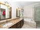 Bathroom featuring double sinks with granite countertops, bathtub, and a tiled shower at 4108 4108 Gallatree Ln, Raleigh, NC 27616
