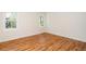 Empty bedroom with wood floor and two windows at 4108 4108 Gallatree Ln, Raleigh, NC 27616