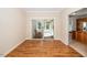 Bright dining room featuring wood floors and access to sunroom at 4108 4108 Gallatree Ln, Raleigh, NC 27616