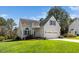 Inviting home featuring manicured lawn, two-car garage, and a welcoming front entry at 4108 4108 Gallatree Ln, Raleigh, NC 27616