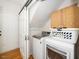 Laundry room with washer, dryer, cabinets, and sliding door at 4108 4108 Gallatree Ln, Raleigh, NC 27616