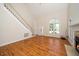 Spacious living room featuring hardwood floors, fireplace, large windows and staircase to the second floor at 4108 4108 Gallatree Ln, Raleigh, NC 27616