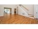 Spacious living room with gleaming hardwood floors, staircase, and access to a sunroom at 4108 4108 Gallatree Ln, Raleigh, NC 27616
