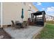 Outdoor patio area with dining set and umbrella, leading to a raised deck featuring a gazebo at 4619 Paces Ferry Dr, Durham, NC 27712