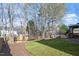 Expansive backyard with mature trees, lush lawn, wood-chipped areas, and a glimpse of the gazebo at 4619 Paces Ferry Dr, Durham, NC 27712