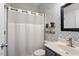 Charming bathroom featuring a shower with patterned wallpaper and a storage shelf for added convenience at 4619 Paces Ferry Dr, Durham, NC 27712