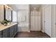 Modern bathroom featuring a gray vanity, a bathtub, and a shower adding a touch of elegance at 4619 Paces Ferry Dr, Durham, NC 27712
