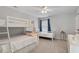 Bright bedroom with a bunk bed, a twin bed, and a ceiling fan providing a cozy atmosphere at 4619 Paces Ferry Dr, Durham, NC 27712