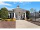 Well-maintained community center with a covered entrance, manicured landscaping, and convenient parking at 4619 Paces Ferry Dr, Durham, NC 27712