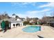Aerial view of the sparkling community pool surrounded by a deck, seating, and lush greenery at 4619 Paces Ferry Dr, Durham, NC 27712