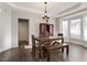 Open dining room area featuring hardwood floors, natural light, and a wooden table with seating at 4619 Paces Ferry Dr, Durham, NC 27712