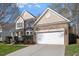 Charming two-story home featuring a combination brick and siding exterior with a 2-car garage at 4619 Paces Ferry Dr, Durham, NC 27712
