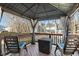 Inviting gazebo with seating on a wooden deck, perfect for outdoor relaxation and entertaining guests at 4619 Paces Ferry Dr, Durham, NC 27712