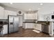 Modern kitchen with stainless steel appliances, granite countertops, and ample cabinet space at 4619 Paces Ferry Dr, Durham, NC 27712