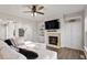 Bright living room featuring a fireplace, built-in cabinets, and a comfortable sofa at 4619 Paces Ferry Dr, Durham, NC 27712