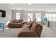Bright living room with comfortable seating, a TV, and plenty of natural light from the surrounding windows at 4619 Paces Ferry Dr, Durham, NC 27712