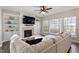 Inviting living room featuring a fireplace, built-in shelving, and a plush white sofa at 4619 Paces Ferry Dr, Durham, NC 27712