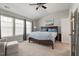 Cozy bedroom with a large bed, soft carpet, and ample natural light from large windows at 4619 Paces Ferry Dr, Durham, NC 27712