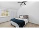 A naturally lit bedroom includes built in closet space, overhead lighting, and backyard views at 4633 Edwards Mill Rd, Raleigh, NC 27612