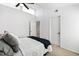 This bedroom includes a fan, neutral walls, and access to additional bedrooms at 4633 Edwards Mill Rd, Raleigh, NC 27612