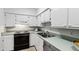Functional kitchen with white cabinets, and essential appliances for culinary endeavors at 4633 Edwards Mill Rd, Raleigh, NC 27612