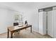 Bright home office featuring a wooden desk, comfortable chair, and natural light from the window at 4633 Edwards Mill Rd, Raleigh, NC 27612