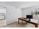 Bright office space with a wooden desk, plush carpeting and access to the kitchen at 4633 Edwards Mill Rd, Raleigh, NC 27612