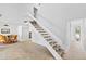 A white staircase connects the levels, adjacent to the dining and living areas at 4633 Edwards Mill Rd, Raleigh, NC 27612