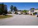 Street view of well-maintained apartment complex, lush trees, and ample parking at 4633 Edwards Mill Rd, Raleigh, NC 27612