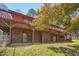 View of the back of a two-story home with two patios overlooking the spacious backyard at 501 Hiddenbrook Dr, Durham, NC 27703