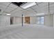 Spacious carpeted basement featuring a brick fireplace, access to stairs and sliding doors to the backyard at 501 Hiddenbrook Dr, Durham, NC 27703