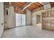 Unfinished basement with sliding glass doors and a doorway into the finished part of the basement at 501 Hiddenbrook Dr, Durham, NC 27703