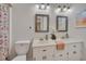 Bathroom features a double vanity, neutral color scheme, framed mirrors, and floral curtain at 501 Hiddenbrook Dr, Durham, NC 27703
