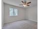 Carpeted bedroom with ceiling fan and one window offering lots of natural light at 501 Hiddenbrook Dr, Durham, NC 27703
