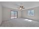 Bedroom with a ceiling fan, a window for light and sliding glass doors to the balcony at 501 Hiddenbrook Dr, Durham, NC 27703