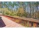 Wooden deck with railing overlooks a lush, wooded backyard providing a tranquil setting at 501 Hiddenbrook Dr, Durham, NC 27703