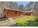 Charming single-story home with a metal roof, wood siding, and an attached garage at 501 Hiddenbrook Dr, Durham, NC 27703