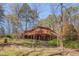 Home features a large deck for outdoor living and a wooded backdrop at 501 Hiddenbrook Dr, Durham, NC 27703