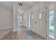 Bright foyer features new flooring, coat closet, and charming white doors with glass insert at 501 Hiddenbrook Dr, Durham, NC 27703