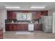 Modern kitchen with stainless steel appliances, wood cabinets, and a view to backyard at 501 Hiddenbrook Dr, Durham, NC 27703