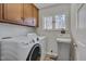 Well-lit laundry room with washer, dryer, storage, and a window providing natural light at 501 Hiddenbrook Dr, Durham, NC 27703