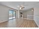 Open living space featuring vaulted ceilings, fan, wood floors, built-ins, and sliding glass doors to deck at 501 Hiddenbrook Dr, Durham, NC 27703