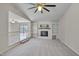A well-lit living room with a fireplace and custom built-in shelving and soft carpet at 501 Hiddenbrook Dr, Durham, NC 27703